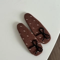 Detailed view of brown fabric hair clips with white stitching and black bow accents - Black Bow / Khaki Waterdrop Hair Clips