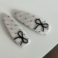 Detail of cream cotton linen hair clips with brown stitching and black bow accents - Black Bow / White Waterdrop Hair Clip