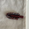 Close-up of handmade woven hair clip with multi-color yarn on red metal duckbill base - Red (with White Red Wool/No Bow)