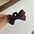 Nahaufnahme einer Hand, die eine klassische rot-grüne Karo-Schleife Haarspange aus Stoff hält - 1# Blau-Rot Karierte Schleife Kleine Haarklammer