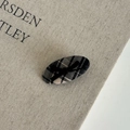 Detail view of oval fabric hair clip with black and white checkered pattern and a small bow - 4# Black Gray Oval Hair Clip with Bow