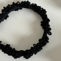 Detailed top view of black crochet knit headband with soft satin lining for winter - Black Plush Headband