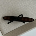 Vintage checkered fabric hair clip with a black velvet bow on grey texture background - Khaki Striped Oval With Black Bow