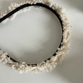 Detail view of plush faux fur headband with soft curly yarn texture in cream white - White Plush Headband