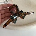 Detailed macro of vintage acetate hair claw clip featuring green marble and brown leopard print - Long Leopard Claw Clip Bow