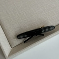 Elegant black and grey plaid hair clip with center black bow on a gold base - Black Striped Oval With Black Bow