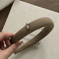 Detail of a brown thick wool sponge headband featuring a metallic bow oval ornament - Coffee Oval Bow