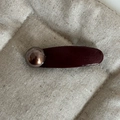 Macro detail of dark brown faux leather hair clip with a vintage metallic pearl ornament - Wine Red Curved Grey Pearl