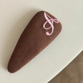 Detail of a brown corduroy hair clip featuring an embroidered pink letter A - Coffee Triangle Clip Pink Letter (11#)