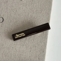 Detail van de koffiebruine haarclip van hars met gouden Barrette La France tekst - Khaki Eendenbekklem Stijl