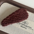 Detailed view of a dark brown knitted BB hair clip with retro ribbed wool texture - Brick Red Striped