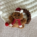 Detail of plush Christmas bear hair scrunchie with festive red hat and scarf accessory - Gingerbread Man Santa Hat Hair Tie