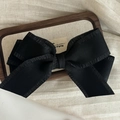 Elegant large black satin ribbon hair clip with ruffled edges on a wooden tray - Black Bow Hair Clip / Black