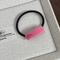 Detail of pink resin hair tie with handmade inscription on a black elastic band - Solid Pink Hair Rope