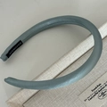 Padded grey-blue satin headband with a textured leather-like finish and handmade label - Glossy Blue