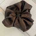 Close-up of a large dark brown satin scrunchie showing smooth fabric texture and soft folds - Khaki