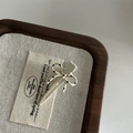 Detailed macro view of a cream bow hair clip with black polka dots on a linen display - 7# Small Cream White Duckbill Clip Cream White Bow