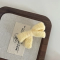 Macro shot of yellow knitted bow hair clip with textured weave on a wooden tray - 4# Yellow Woolen Bow Hair Clip