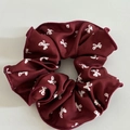 Detailed texture of burgundy scrunchie with white butterfly patterns and sewn edges - Burgundy Butterfly Pattern Hair Tie with White Bowknot