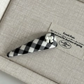 Detailed macro view of black and white checkered fabric hair clip with resin bow decoration - Black White Grid Triangle with White Bow