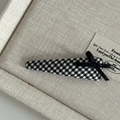 Detail of British style black and white plaid hair clip with a delicate black silk bow - Small Black White Grid Triangle Fabric with Black Bow