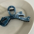 Detailed macro view of the blue marble ink pattern on the acetate claw clip texture - Blue Cross-Shaped Claw Clip