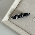Detail of plaid barrette with three black bows on textured fabric background - Black White Grid Oval with Three Black Bows