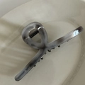 Detailed macro view of the grey marble texture and teeth on the large acetate hair claw clip - Grey Large Cross Claw Clip
