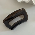 Detail of a large dark brown translucent rectangle hollow hair claw clip with spring - 9# Square Hollow Claw