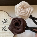 Detail of elegant 3D fabric rose hair pins in cream and dark brown for bun styling - 3D Flower (Brown) / Brown
