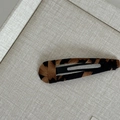 Detailed view of leopard print fabric texture on a square black snap hair clip - Leopard Print Teardrop Clip