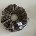 Macro detail of brown plaid scrunchie with layered fabric edges and silver bow label - Khaki White Plaid (3#)