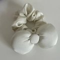 Detailed view of large white satin bow scrunchie featuring smooth silk texture and sheen - White Ink Bow Scrunchie