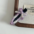 Detail of a purple tweed duckbill hair clip with a bow on a wooden display stand - Purple White Plaid Woven Seamless Clip