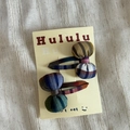 Close-up of colorful checkered padded bow hair clips on a branded paper card - Colorful Striped Chubby Bow Style