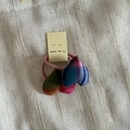 Detail of colorful plaid stuffed heart charms on an elastic pink fabric hair tie - Colorful Striped Heart Hair Tie Style