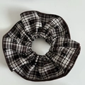 Close-up of brown plaid scrunchie with embroidered black bows and reinforced stitched edges - Large Khaki and White Stripe Scrunchie