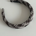 Detail view of handmade plaid headband with classic brown pattern and bow tie accents - Khaki and White Stripe Headband
