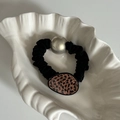 Elegant leopard print scrunchie with large metallic pearl bead on a shell tray - Tortoiseshell Leopard Black Hair Tie