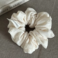 Detail of off-white oversized scrunchie featuring textured crinkle fabric and woven label - White Scrunchie (2#)