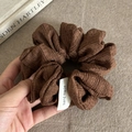 Detail of a brown bubble textured scrunchie with a handmade woven label and soft fabric - Khaki Scrunchie (1#)