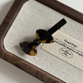 Detail of tortoise shell acetate bow hair clip with gold Barrette La France engraving - Dark Leopard Bow Duckbill Clip
