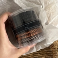 Close-up of elastic hair tie set in a clear round jar with brown braided texture - 6# Black Khaki Caramel