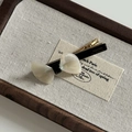 Detail of a creamy acetate bow hair clip with gold Barrette La France lettering - Silver White Texture Bow Duckbill Clip