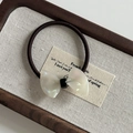Detail of a French style acetate pearl bow hair tie with a brown high-elastic rubber band - Silver White Texture Bow Hair Tie