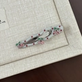 Close-up of wavy cherry hair clip with red polka dots and pink crystal embellishments - White Red Polka Dot Hollow Curved Pink Cherry