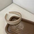 Minimalist beige padded headband with soft fabric texture on a brown display tray - Coffee Smooth Surface Headband (9#)