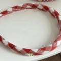 Close-up of red gingham headband featuring a round golden handmade metal tag - Red and White Gingham (No.2)