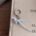 Silver metal bow keychain with light blue ribbon and heart pendant on a soft background - Silver Bow Blue Ribbon