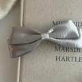 Detail of silver satin bow hair clip with metallic texture and vintage style design - Silver Large Bowknot